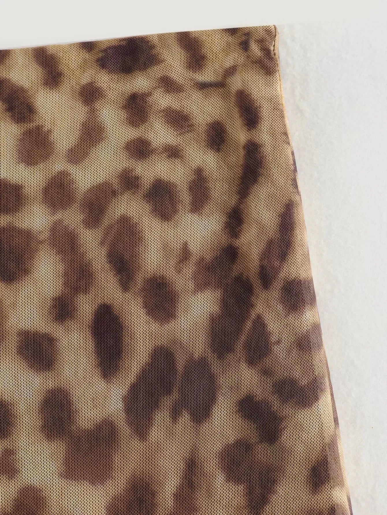 Sophisticated leopard tulle midi skirt, designed for modern elegance.