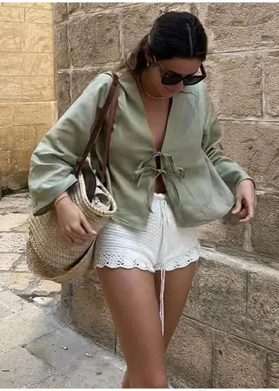 Green linen lace-up long sleeve blouse, perfect for a chic, trendy outfit.