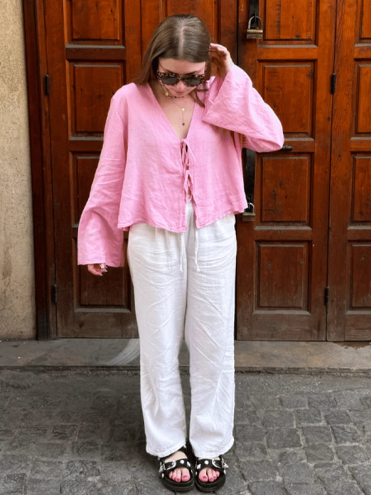 Pink linen lace-up long sleeve blouse, a feminine and elegant wardrobe essential.