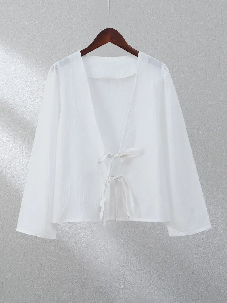 White linen blouse with lace-up detail, perfect for an elegant and minimalist look.