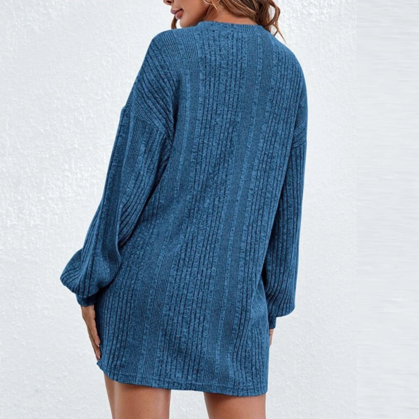 Stylish blue knitted sweater dress with long sleeves, perfect for cozy days.