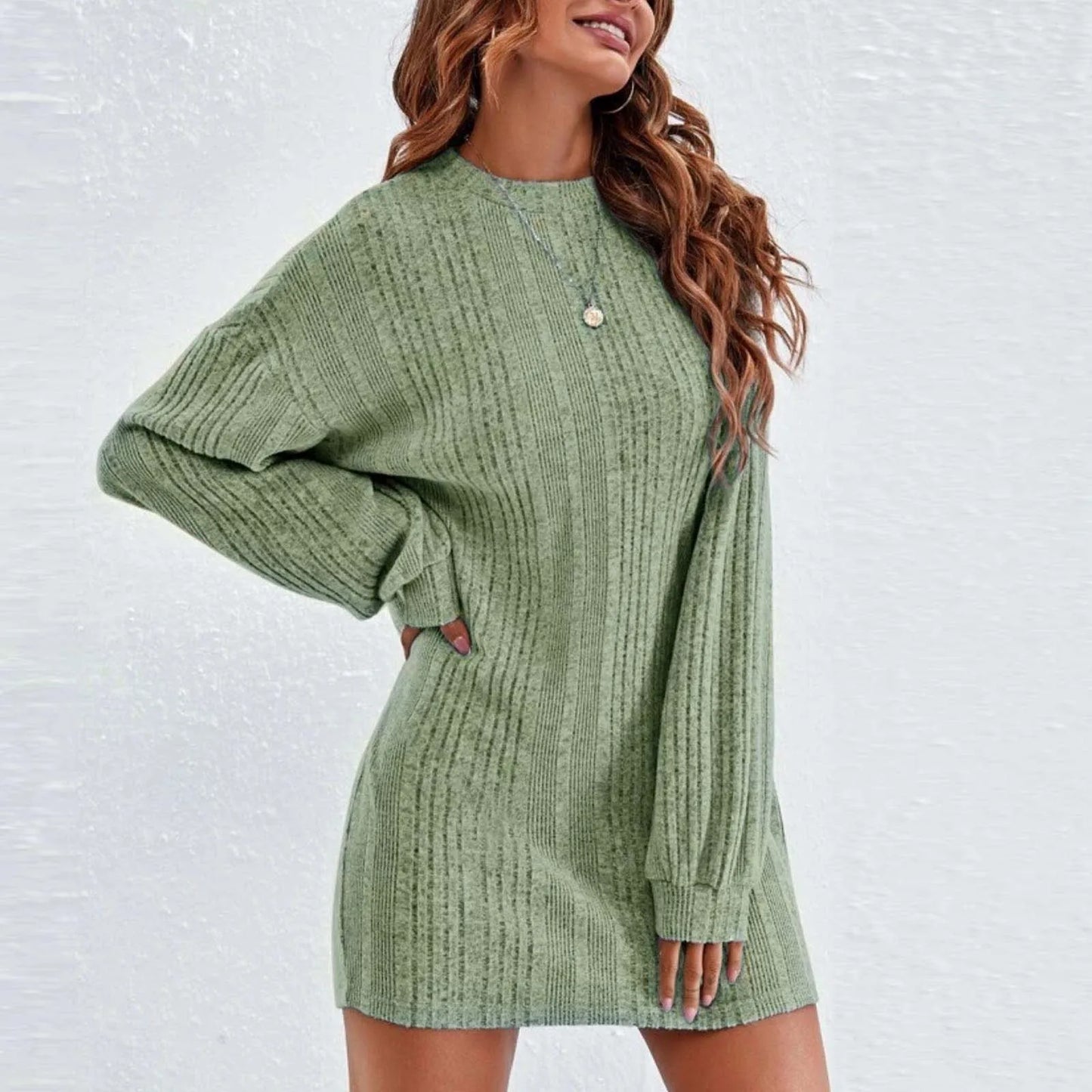 Cozy green knitted sweater dress with long sleeves, blending casual and chic elements.