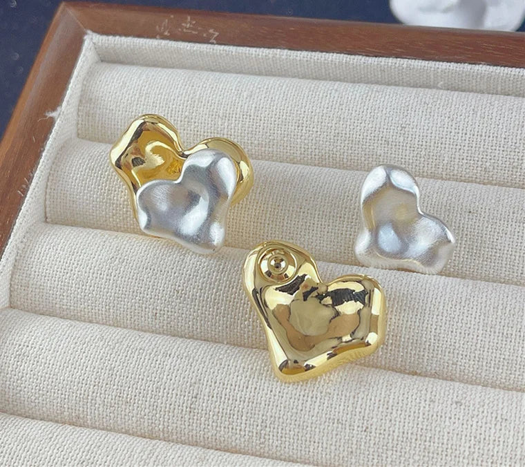 Mixed silver and gold heart earrings, a blend of timeless and elegant design.