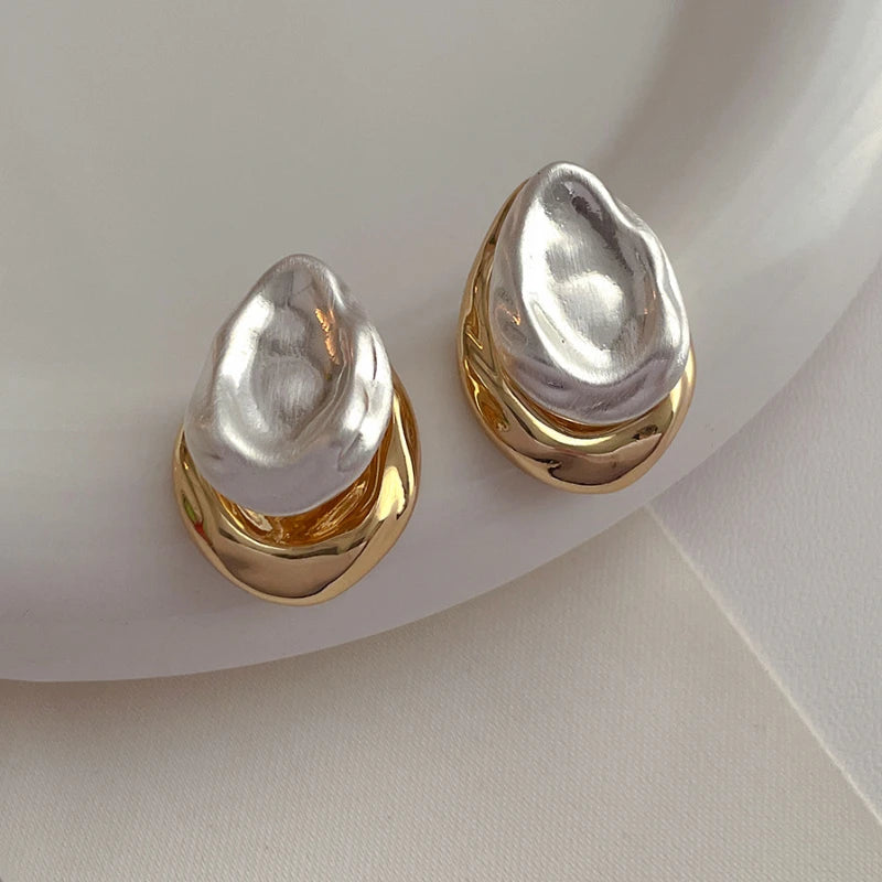 Mixed silver and gold teardrop earrings showcasing a modern, timeless style for chic looks.