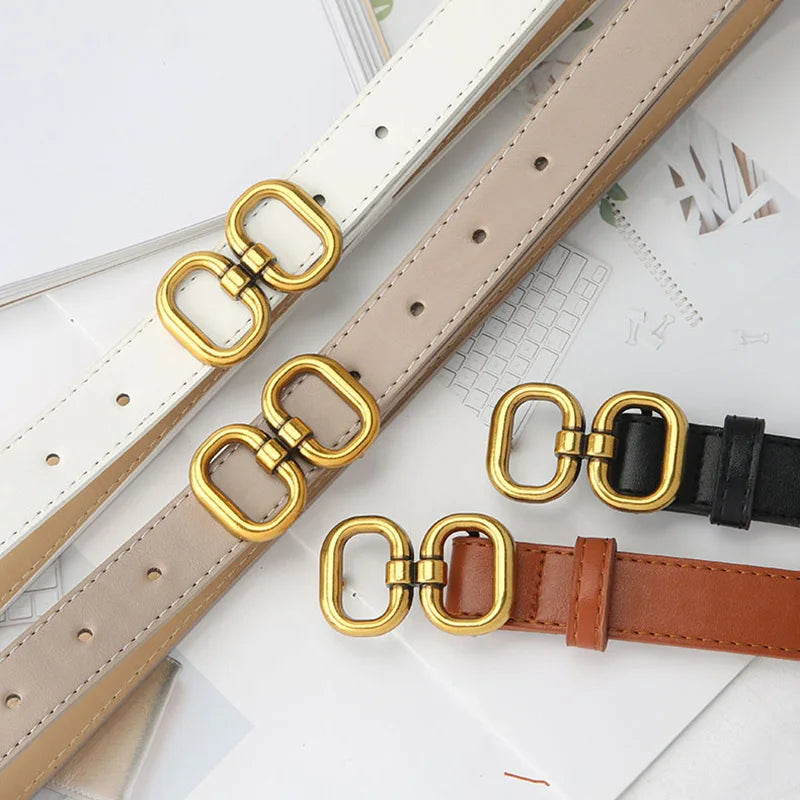 Stylish leather belts in black, white, khaki, and brown with polished metal buckles.