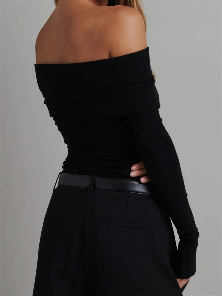 Back view of Black Off-Shoulder Long Sleeve Knitted Tee highlighting the fitted silhouette.
