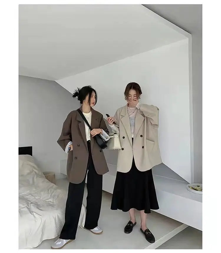 Two models showcasing oversized blazer coats in brown and creamy-white, styled for luxurious fall and winter fashion.