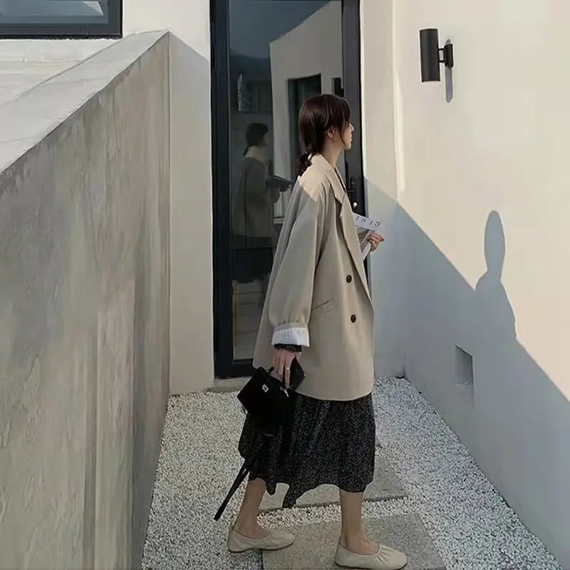 Creamy-white oversized blazer, a classic layering piece for transitional seasons.