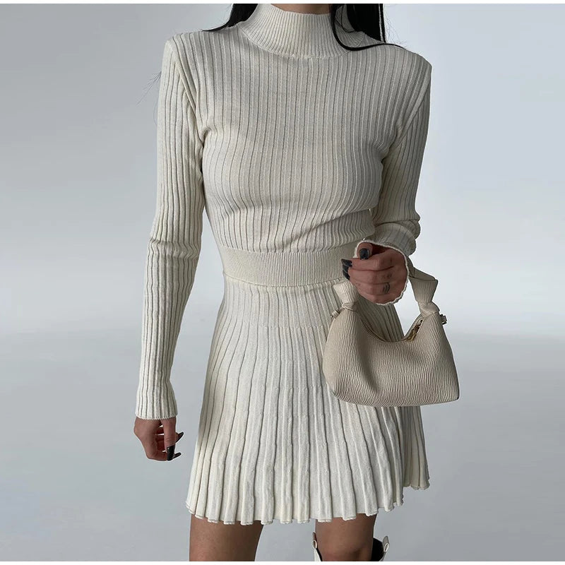 Beige pleated mini dress embodying understated luxury and timeless elegance.