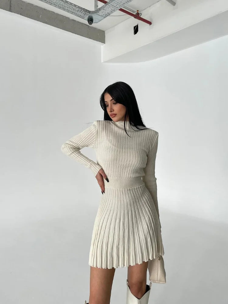 Beige pleated mini dress offering soft neutral tones for effortless fashion.