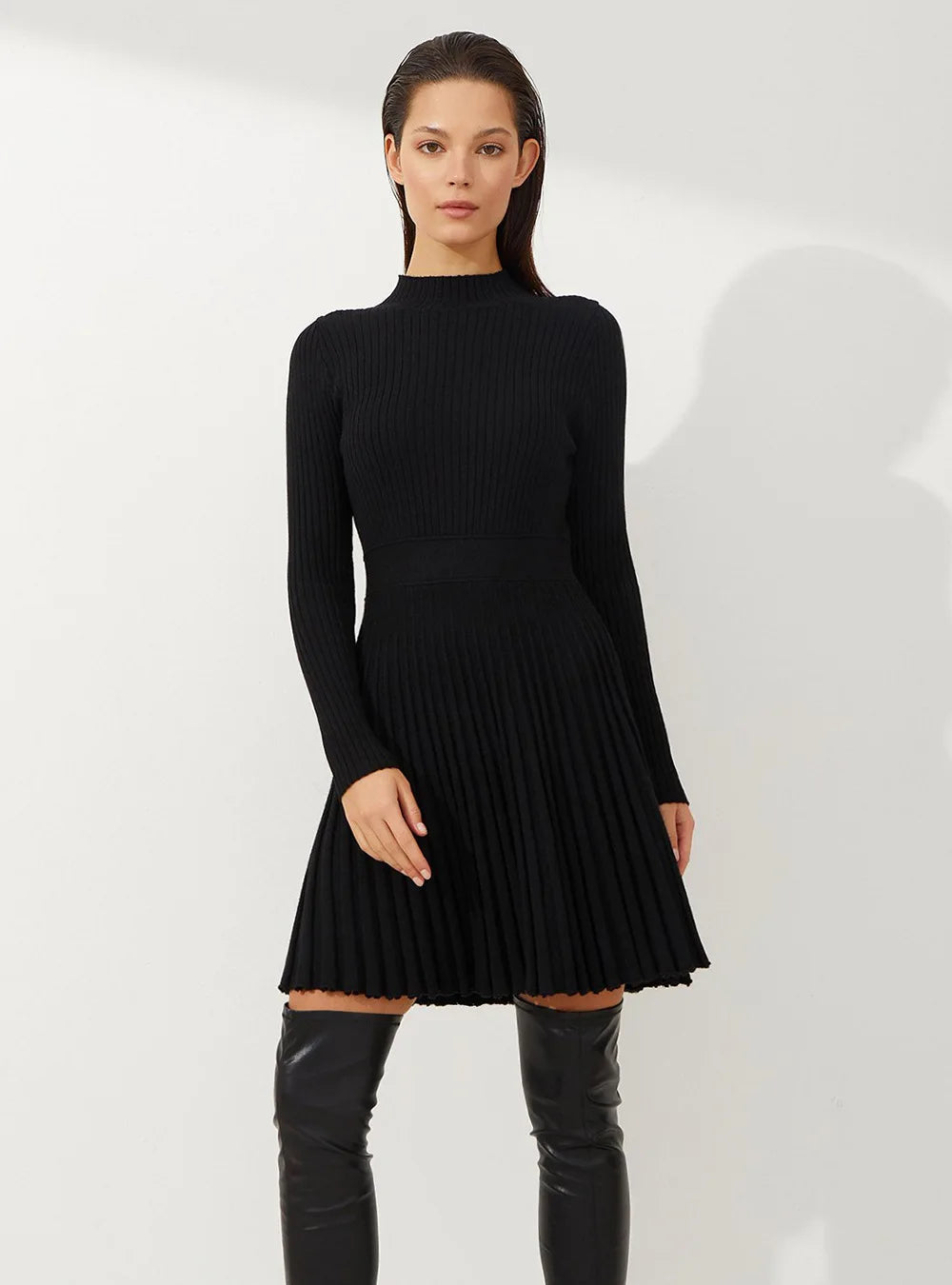 Black pleated mini dress styled for a classic and versatile wardrobe option.