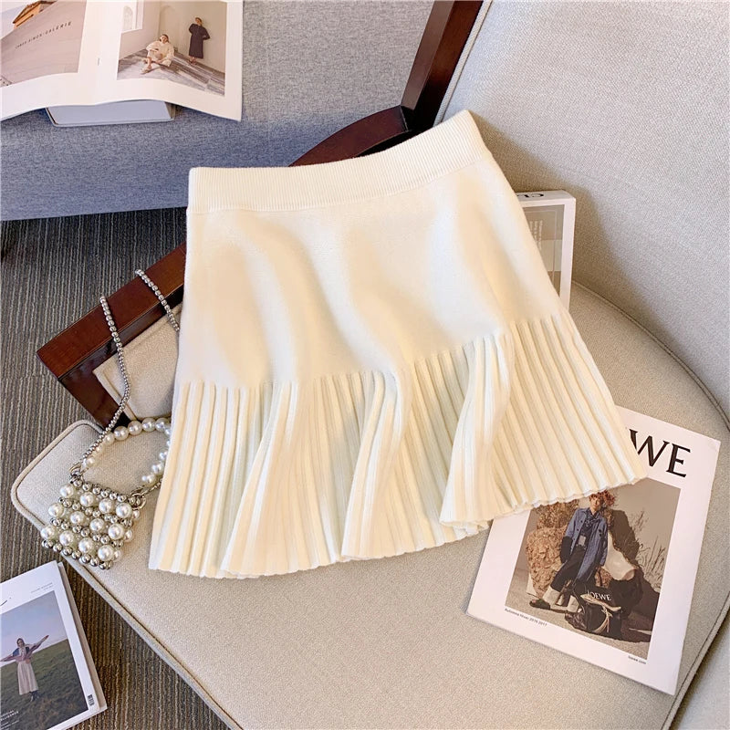 Beige Pleated Mini Skirt displayed against a chic background, perfect for a fashionable look.