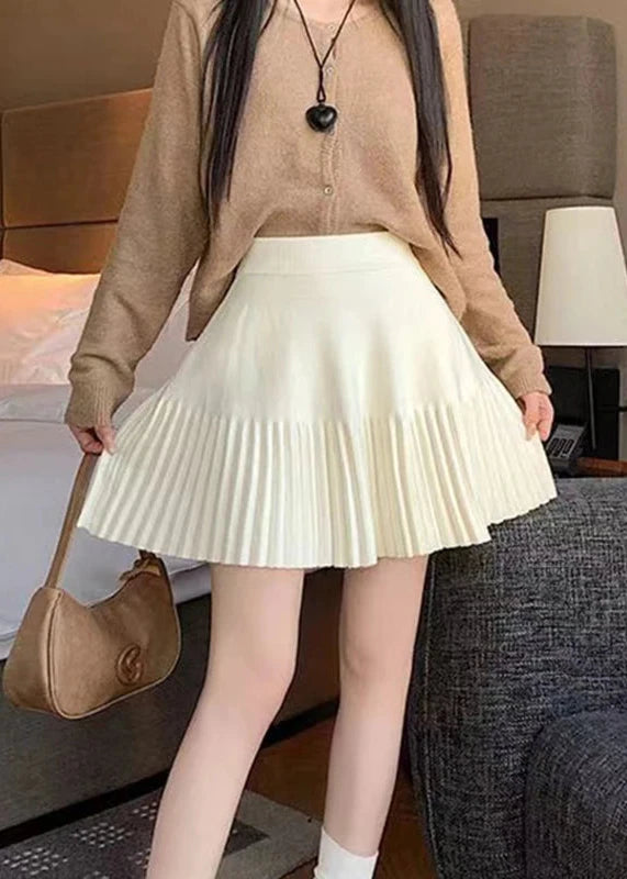 Beige Pleated Mini Skirt worn by model, showcasing a versatile piece for various outfits.