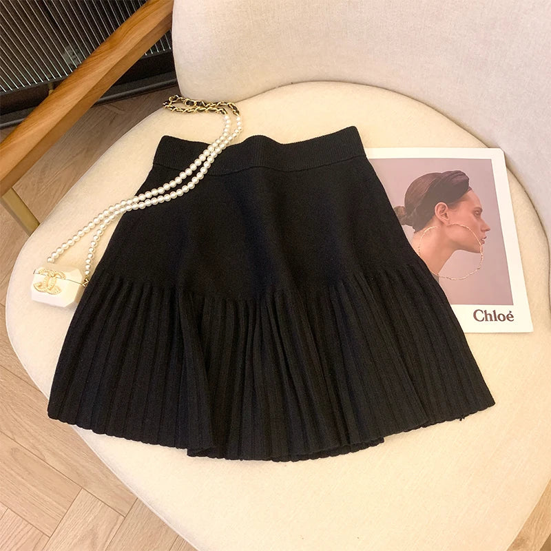 Black Pleated Mini Skirt against a stylish background, ideal for casual and dressy occasions.