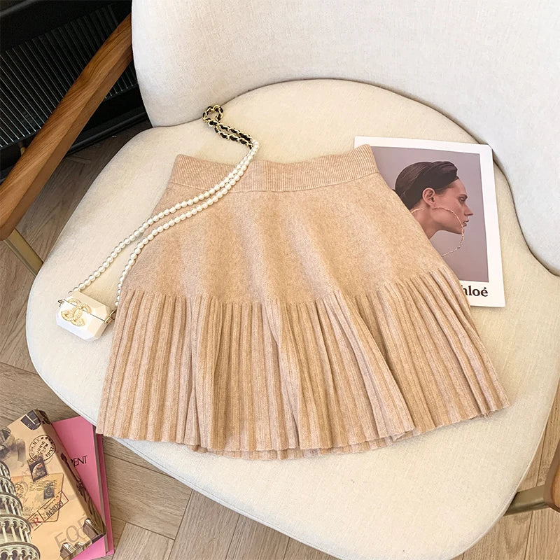 Dark Apricot Pleated Mini Skirt against a stylish background, suitable for casual and dressy settings.