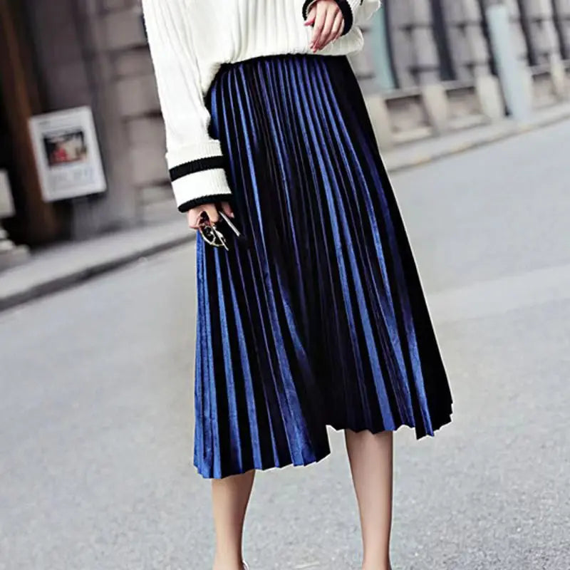 Luxurious royal blue pleated velvet midi skirt featuring an A-line silhouette and mid-calf length for chic autumn style.