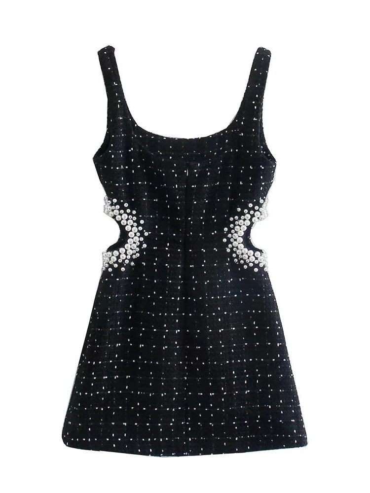 Sophisticated black tweed dress with hollow-out back detail for a modern chic look.