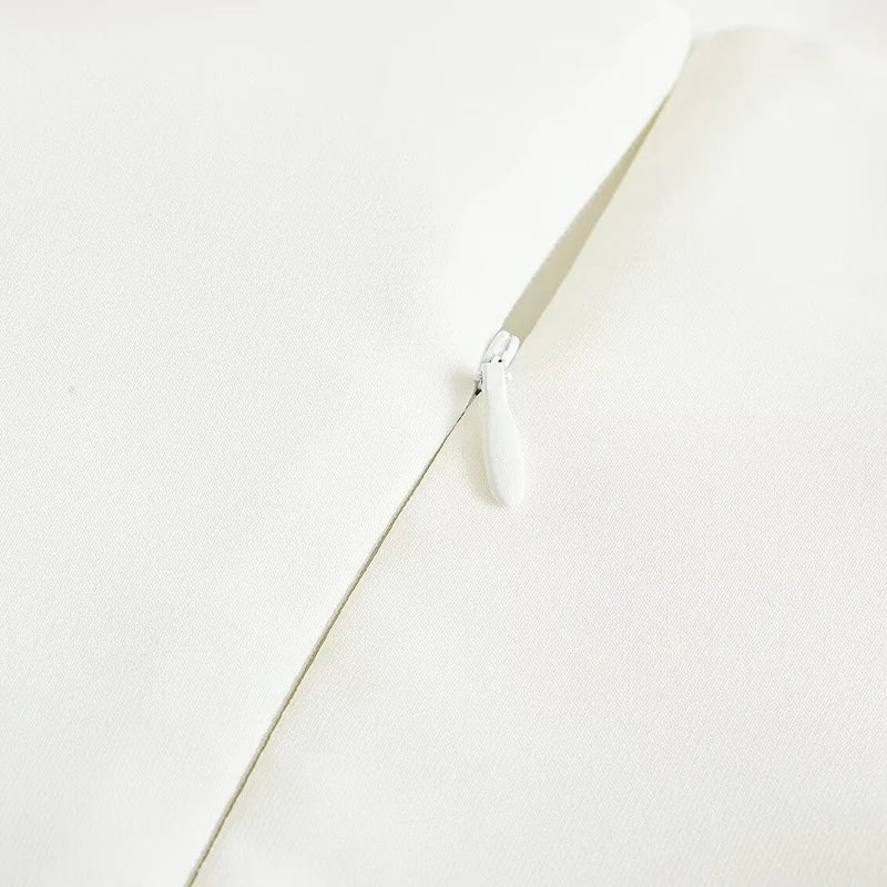 Close-up of the strapless midi dress detailing, highlighting the soft waist folds and luxurious fabric for a refined look.
