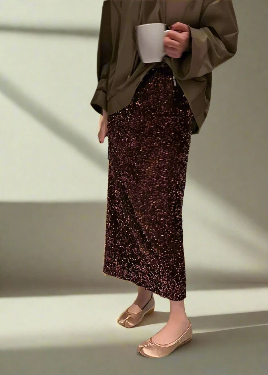 Elegant coffee-colored velvet sequin midi skirt styled for a chic winter evening outfit, perfect for festive events.