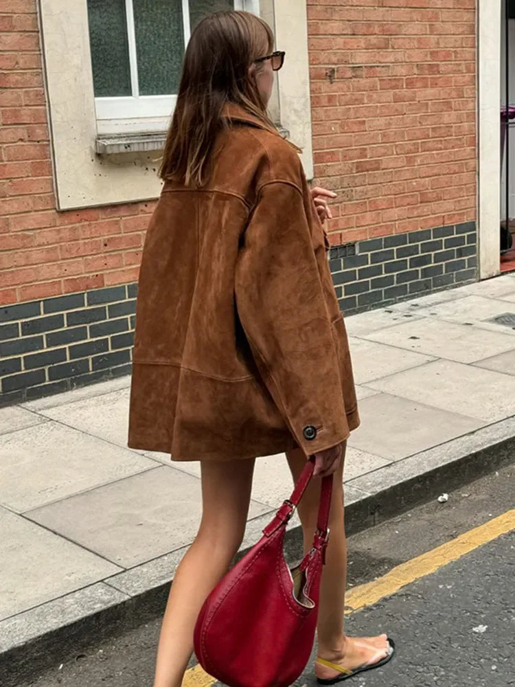 Stylish brown suede jacket layered for an elegant autumn outfit, showcasing seasonal high-street fashion