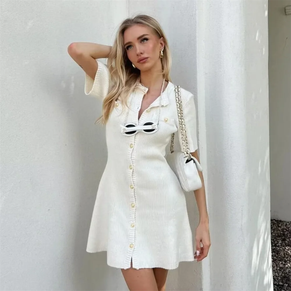 Trendy white short dress made of soft knit, perfect for modern fall or winter styling.