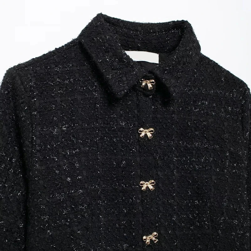 Above-knee black tweed dress with a turn-down collar, showcasing timeless style and elegance.
