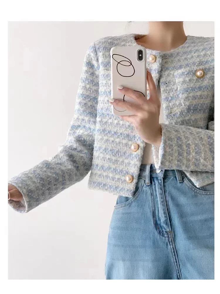 Luxury-style tweed jacket featuring a modern blend of white, blue, and grey, offering timeless elegance for upscale occasions.
