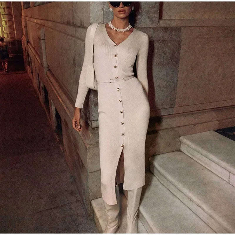 Beige V-neck knitted long dress worn by model, highlighting the elegant and timeless design.