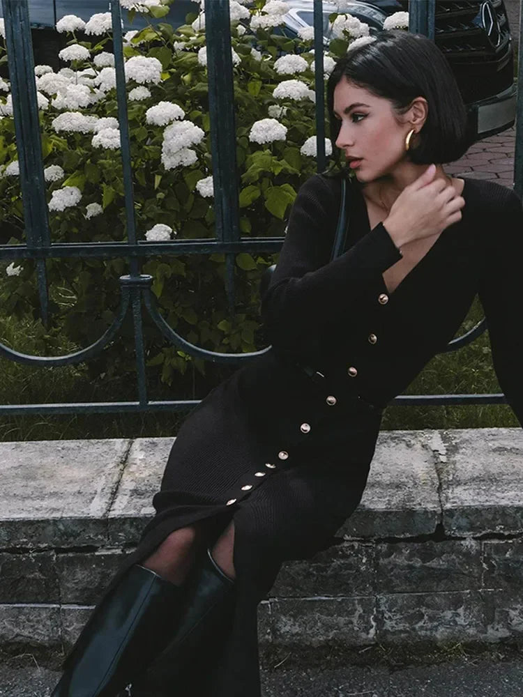 Model sitting in the Black V-neck knitted long dress, demonstrating its comfort and style.