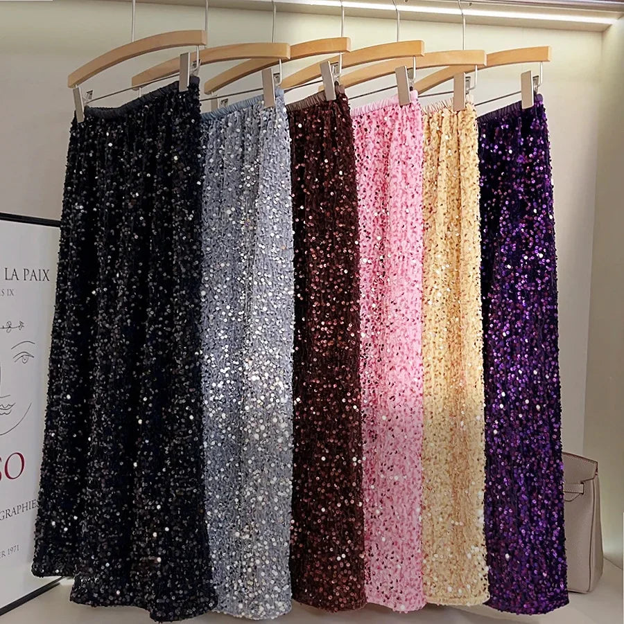A collection of velvet sequin midi skirts in all colors—pink, silver, black, coffee, khaki, purple, burgundy, and beige—neatly displayed on a hanger
