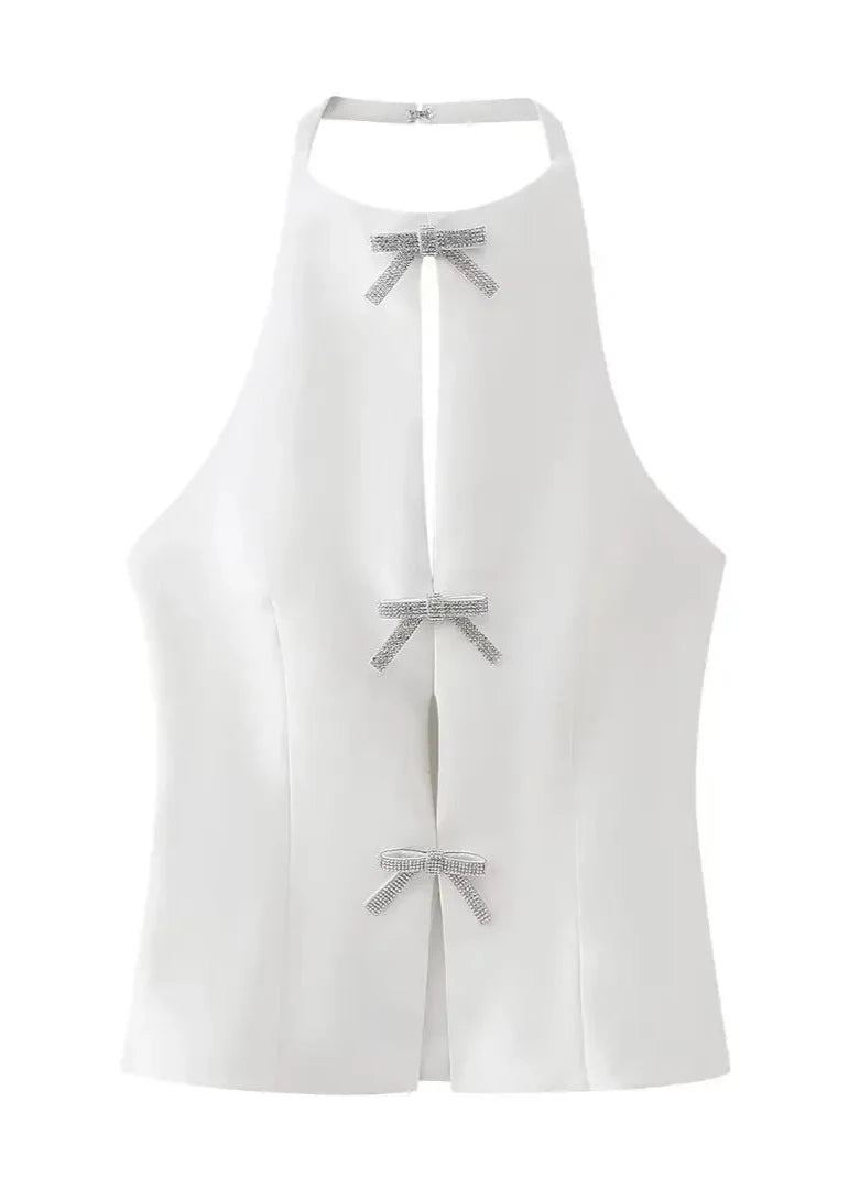 Elegant white halter neck top with diamond bow and backless design for chic evening wear.