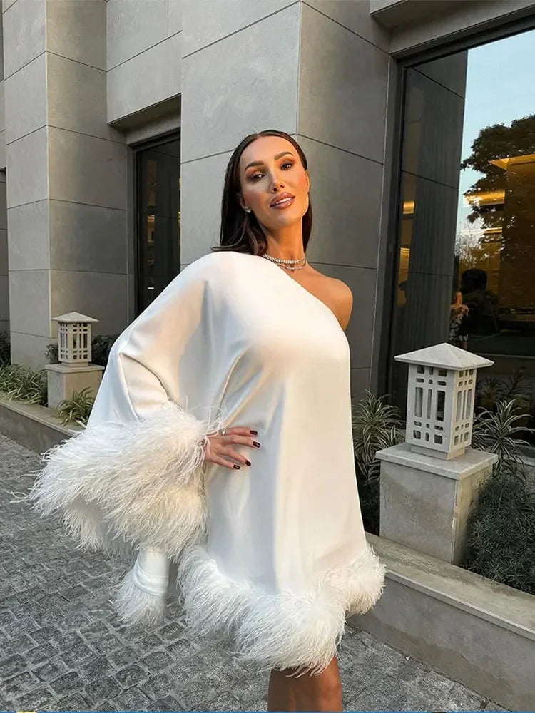 Fashion-forward white one-shoulder mini dress with elegant feather detailing