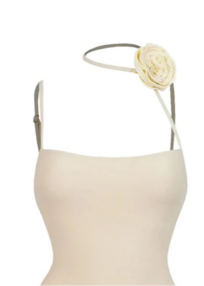Beige swimsuit with floral details and a white background