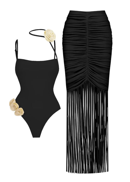 Black swimsuit with ruched design and fringes on a white background