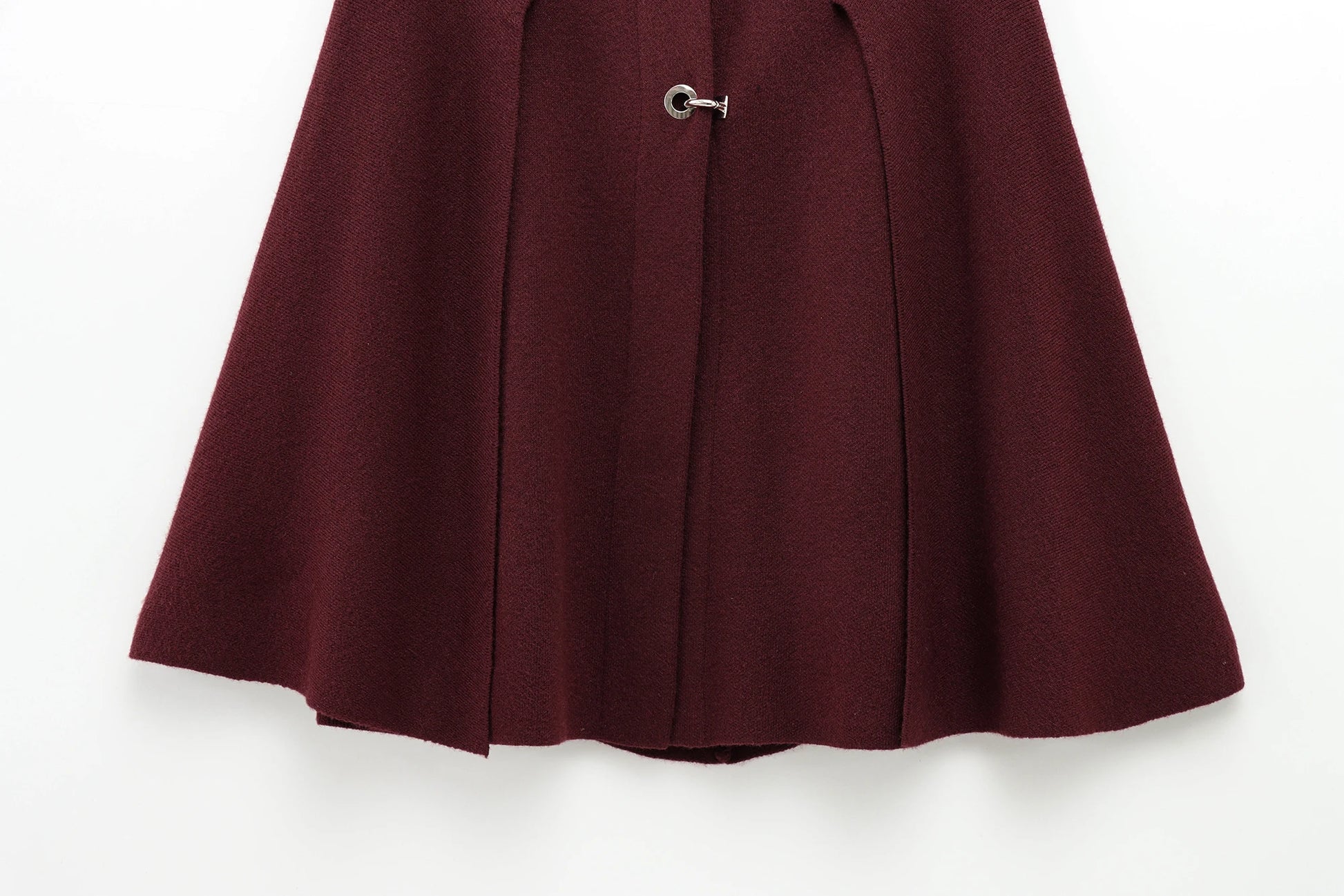 Burgundy cape with a button on a white background