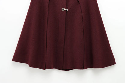 Burgundy cape with a button on a white background