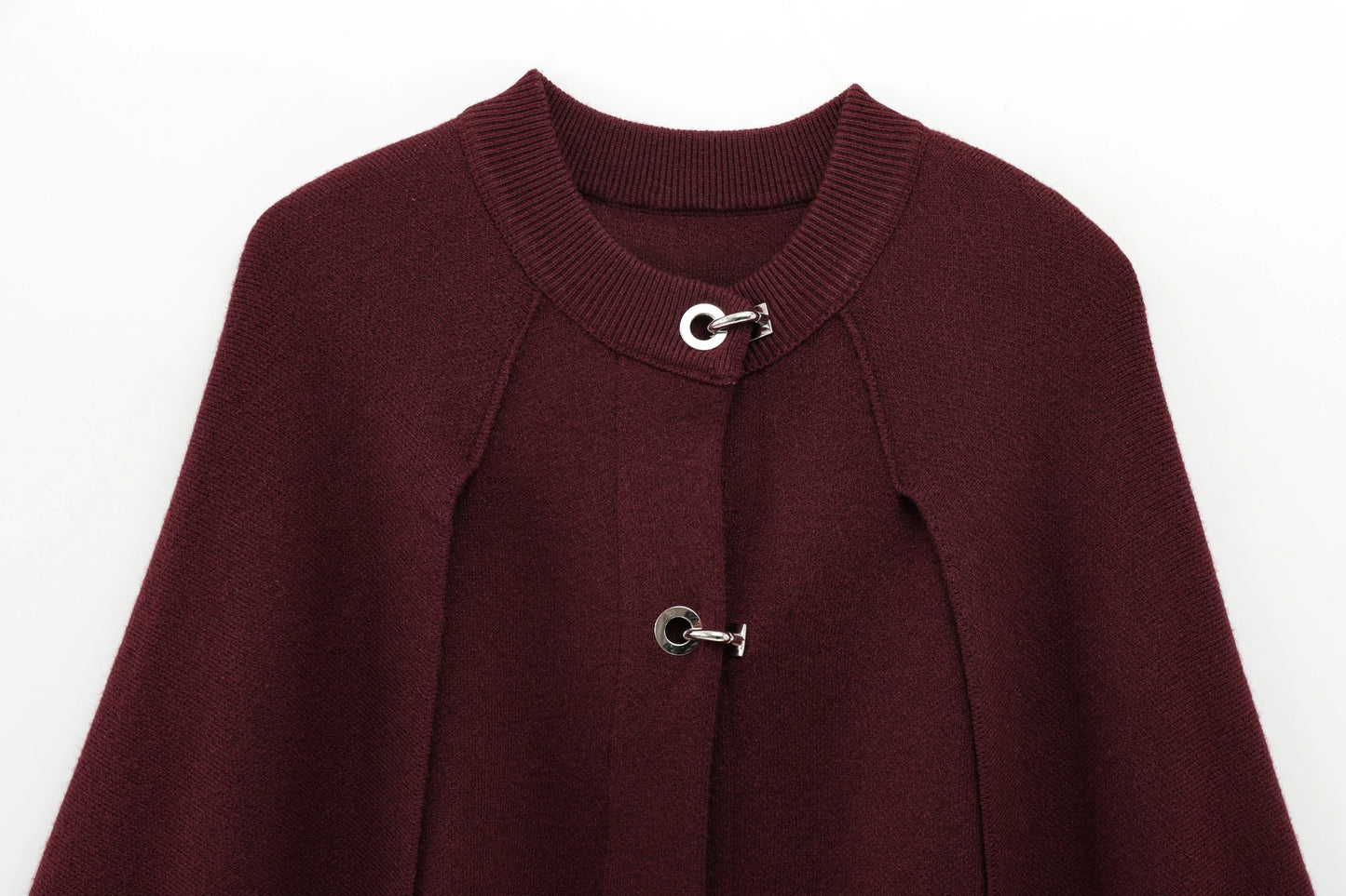Burgundy cape with silver buttons on a white background