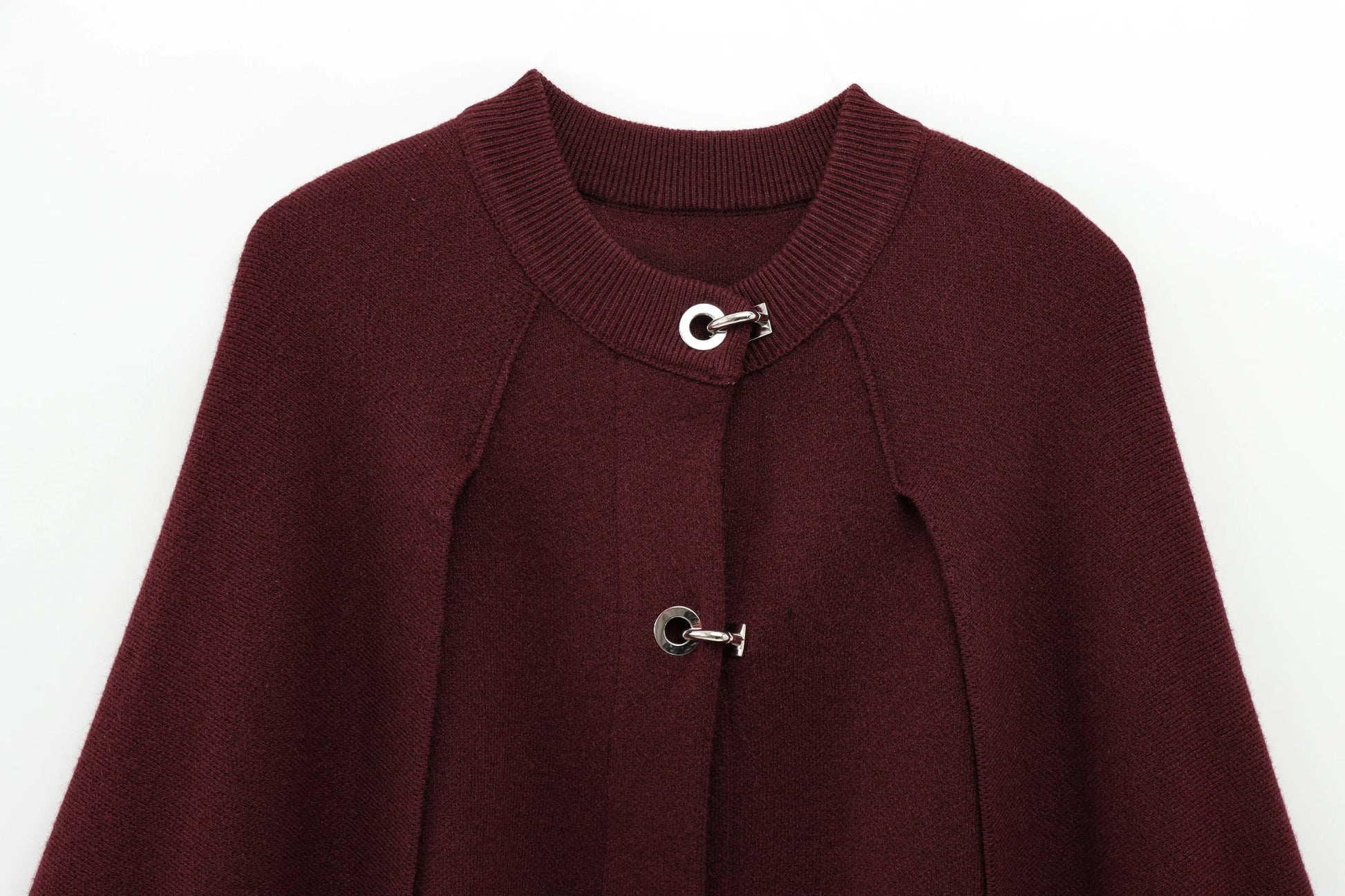 Burgundy cape with silver buttons on a white background