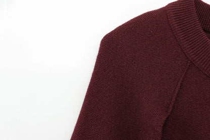 Close-up of a burgundy cape on a white background
