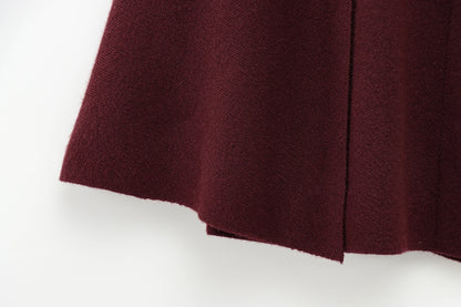 Close-up of a burgundy fabric of a cape with a white background