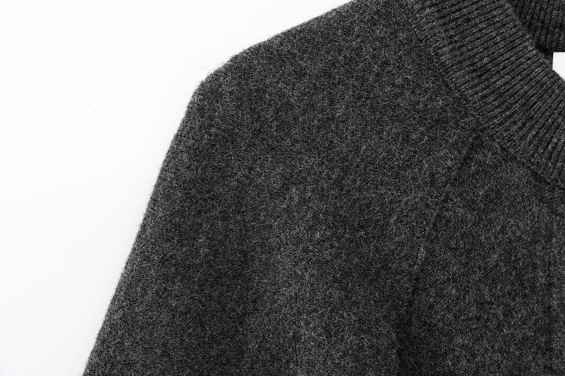 Close-up of a dark gray cape on a white background