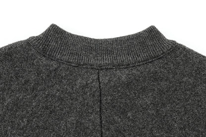 Close-up of a dark gray cape with a ribbed neckline on a white background