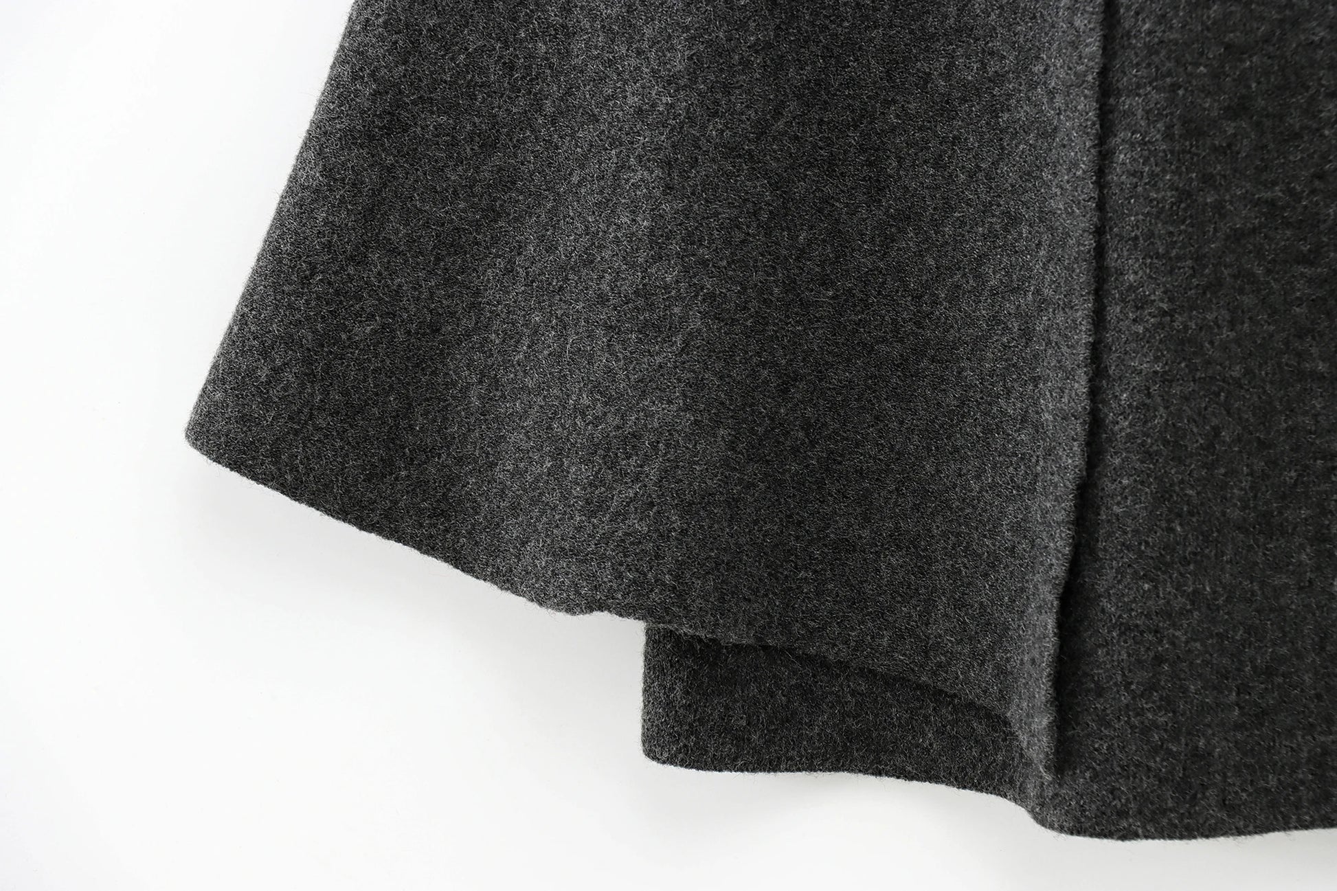Close-up of a dark gray cape on a white background