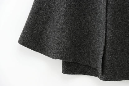 Close-up of a dark gray cape on a white background