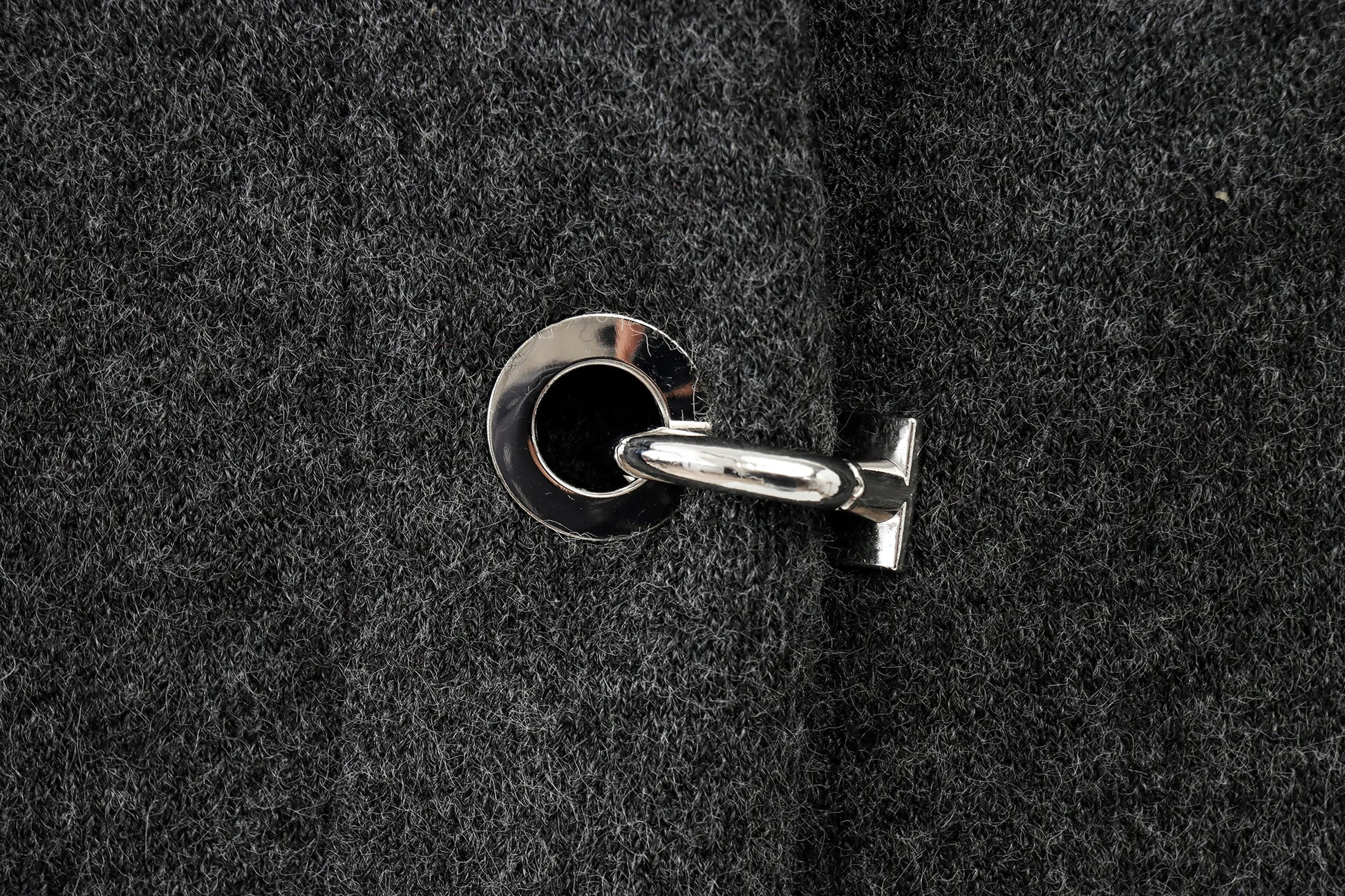 Close-up of a keyhole on a textured black cape