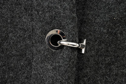 Close-up of a keyhole on a textured black cape