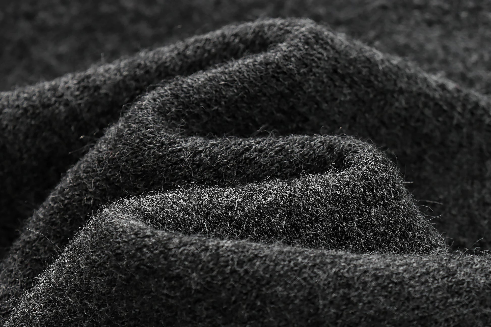 Close-up of dark textured fabric with a focus on texture and color.