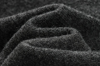 Close-up of dark textured fabric with a focus on texture and color.