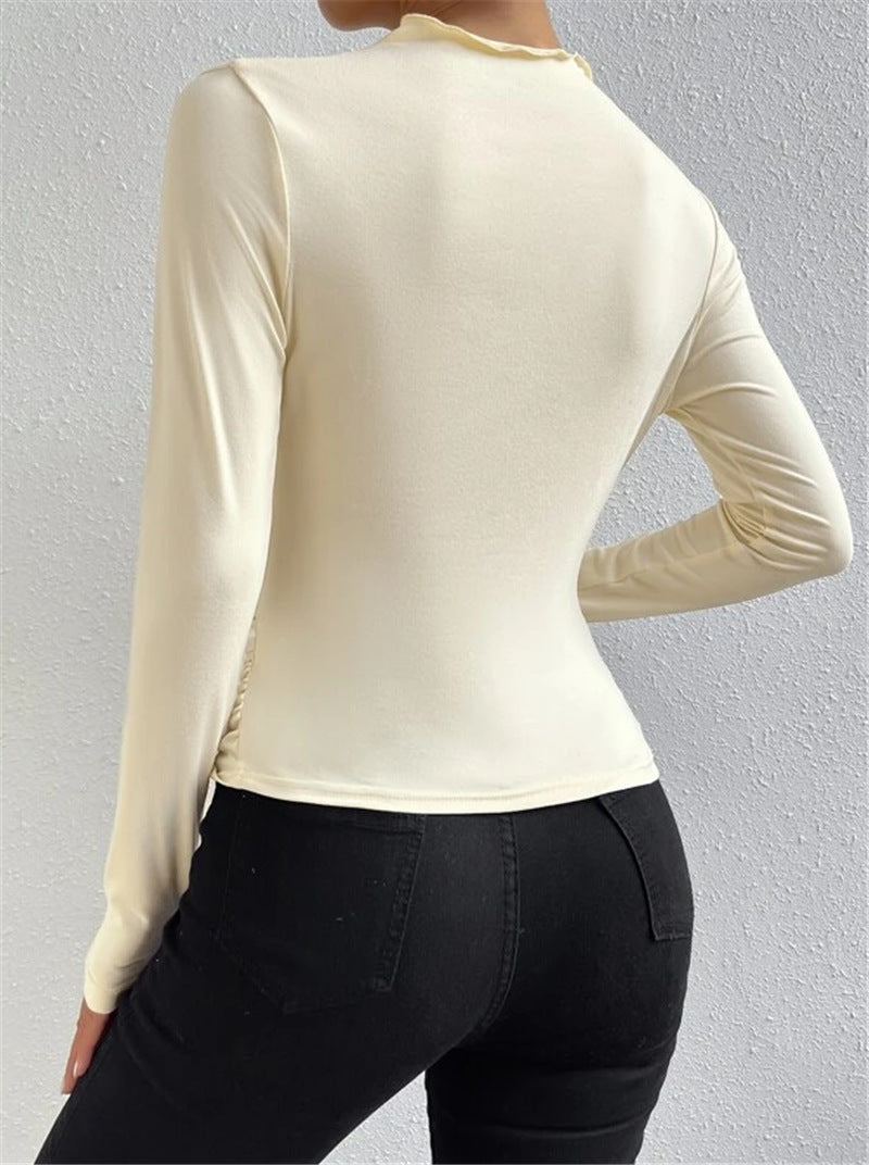 Trendy beige pleated t-shirt with a modern twist, suited for autumn/winter chic looks.